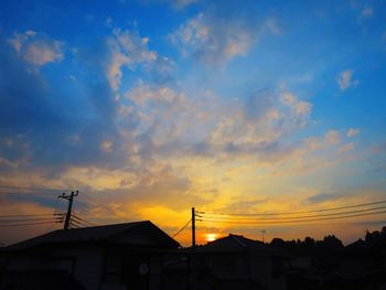 Low angle view of silhouette buildings against sky during sunset