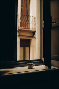 Coffee cup near the window with shutters in turin, italy. enjoy moment, relax lifestyle.