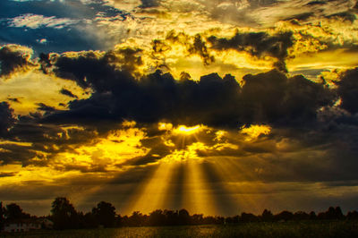 Scenic view of silhouette landscape against orange sky