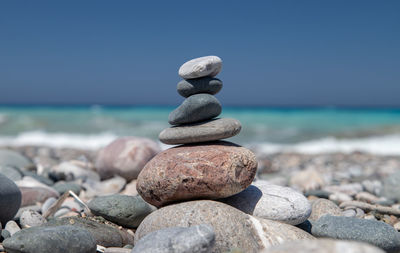 Gravel  beach at the southwest coast of rhodes with small stone figures