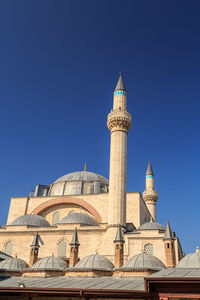 Low angle view of mosque against blue sky