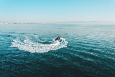 Speed boat in sea against sky