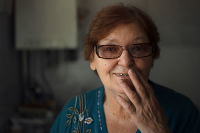 Close-up portrait of smiling senior woman at home