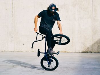 Man riding bicycle on wall