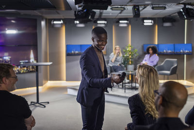 Tv show host interviewing audience member