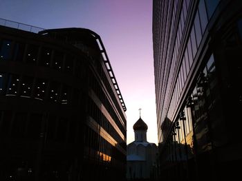 Low angle view of buildings against sky during sunset