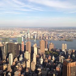 High angle view of buildings in city against cloudy sky