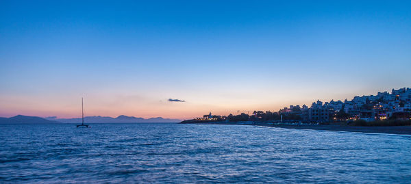 Scenic view of sea against blue sky during sunset