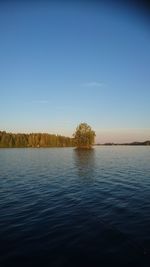 Scenic view of lake against clear blue sky