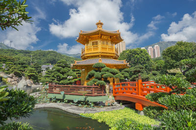 Temple by building against sky