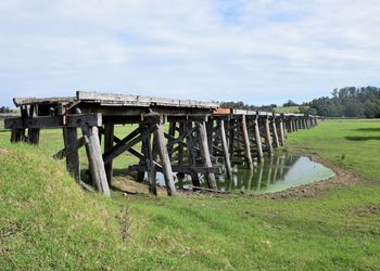 View of bridge over grassy field