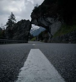 Road by trees against sky