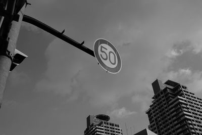 Low angle view of road sign against sky