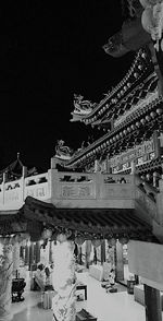 Low angle view of illuminated building against sky at night