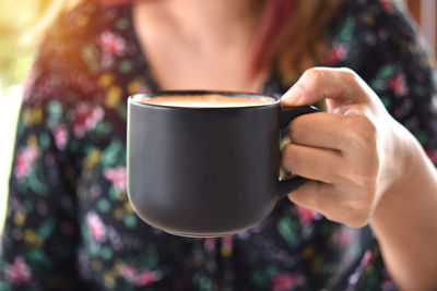 Close-up of woman holding coffee cup