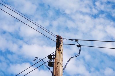 Low angle view of electricity pylon against sky