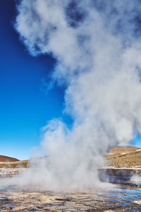 Smoke emitting from volcanic mountain against sky