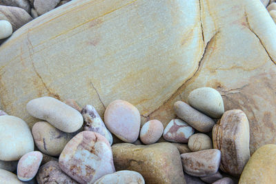 Close up of rounded and polished beach rocks on the sea shore