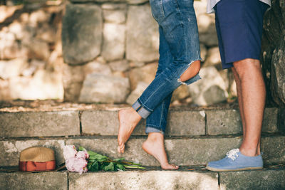 Low section of couple standing on steps