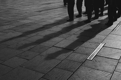 Low section of men standing on street