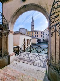 View of historic buildings through a monumental gate