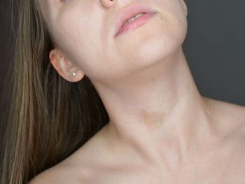 Close-up of woman with hair over black background