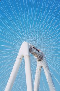 Low angle view of ferris wheel against blue sky