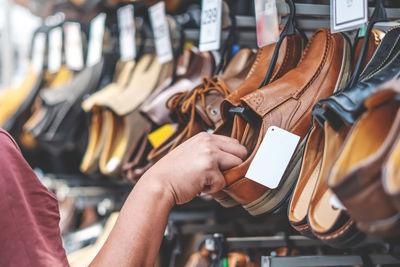 Midsection of man preparing for sale at store