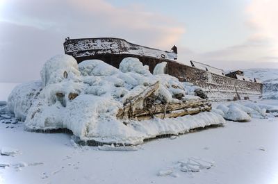 Snow covered shore against sky