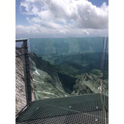 Scenic view of mountains against cloudy sky