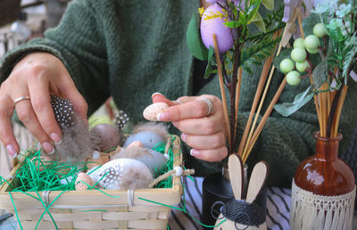 Cropped hand of woman holding seashells