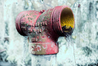 Close-up of water pipe on rusty metal during winter