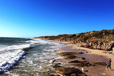 Scenic view of sea against clear blue sky