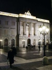 Woman in illuminated city at night