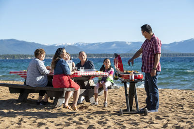 People on beach against sky