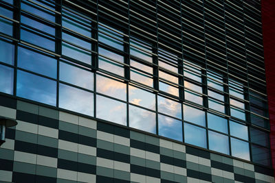 Office building with sky reflection in window. part of house facade. modern city architecture