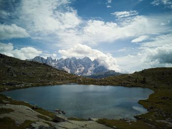 Scenic view of lake by mountains against sky. lake iuribrutto.