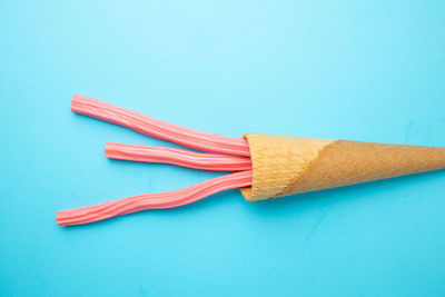 Close-up of colored pencils against blue background