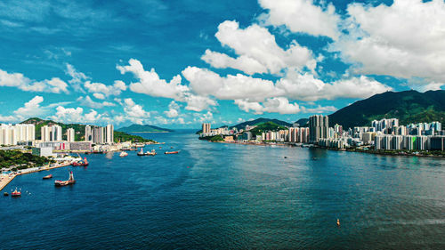 Panoramic view of city buildings against cloudy sky