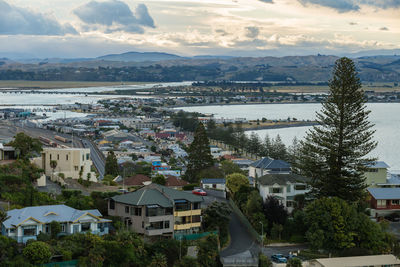 View of cityscape against cloudy sky