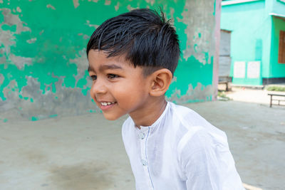 Portrait of smiling boy standing outdoors