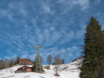 Snow covered land against sky