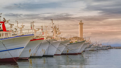 Fishing boats resting at sunset in darsena, viareggio, winter season