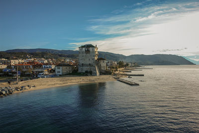 Scenic view of sea and buildings against sky