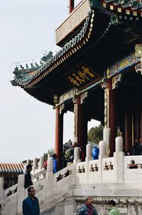 People in temple building against sky