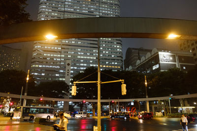 People in illuminated city at night