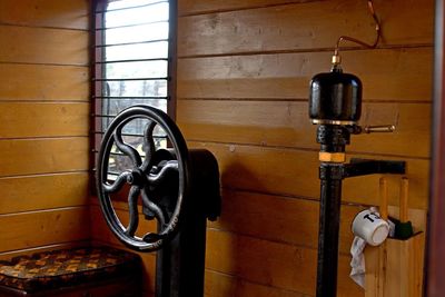 Close-up of old electric lamp hanging on wall