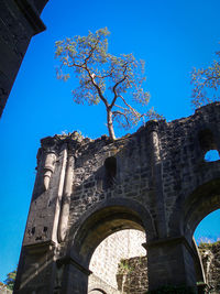 Low angle view of historical building against blue sky