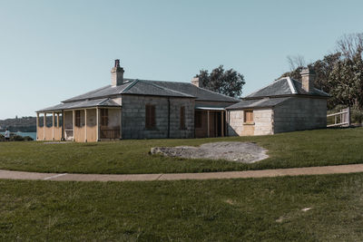 House on field against clear sky