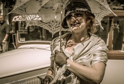 Midsection of smiling woman in car